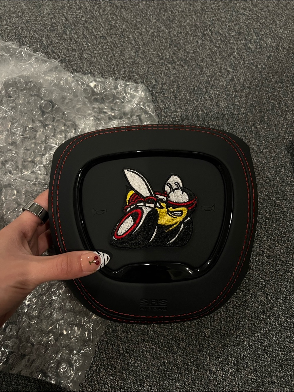 Black Airbag Cover with Red Stitching and Bee Patch